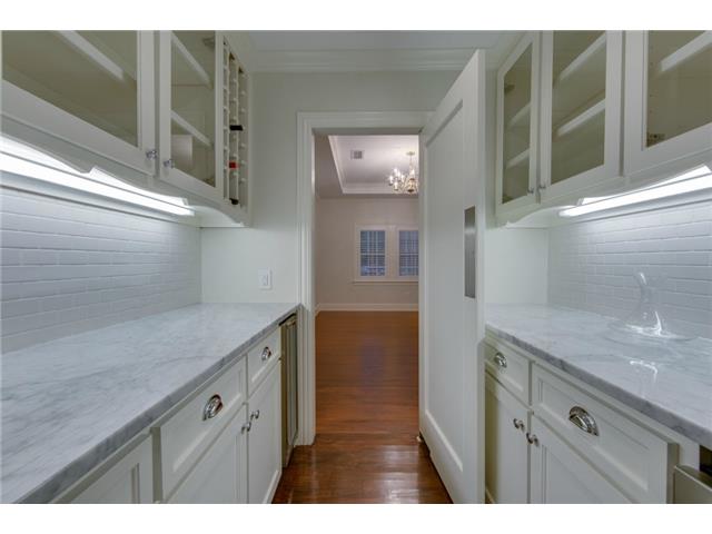 Butler's pantry between kitchen and dining room has wine cooler