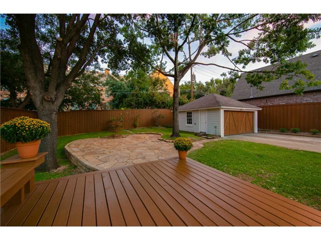 Large deck, flagstone patio and two car garage.
