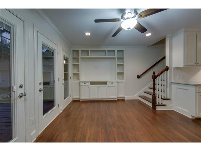 Den with built in storage and doors to deck.
