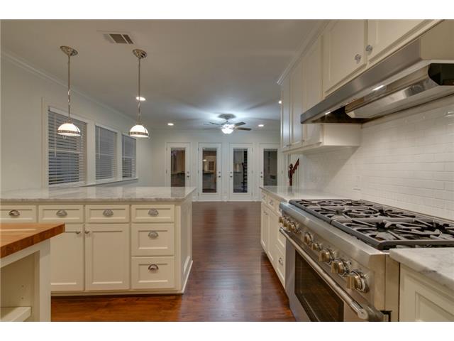 Kitchen looking toward den and doors opening to the deck.
