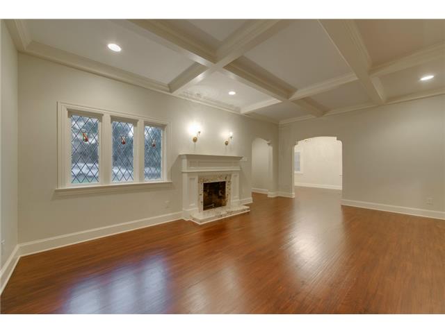 Living room with original windows, hardwood floors, fireplace an