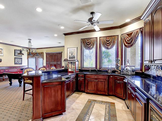 kitchenette open to game room downstairs with dishwasher, refrig ...