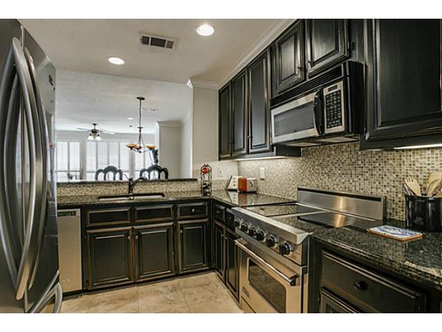 Kitchen with Viking range, travertine floors, glass tiles, grani