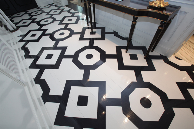 The foyer floor has classic geometric shapes painted on wood.