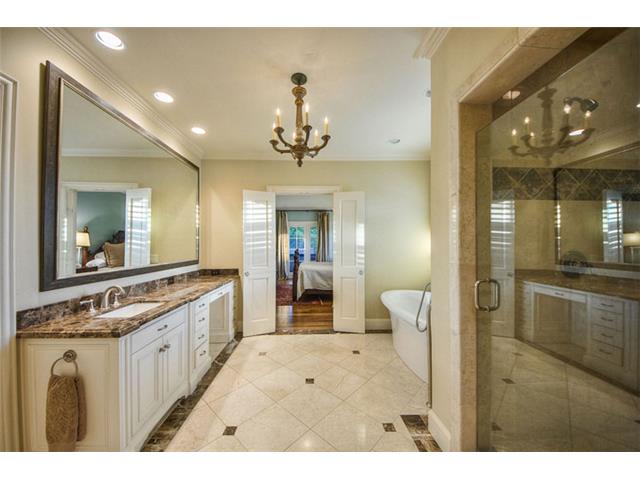The spacious master bath is spa-inspired. Stone flooring, double