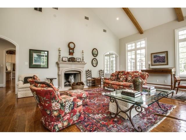 Vaulted den with fireplace and tall windowsoverlooking back of p