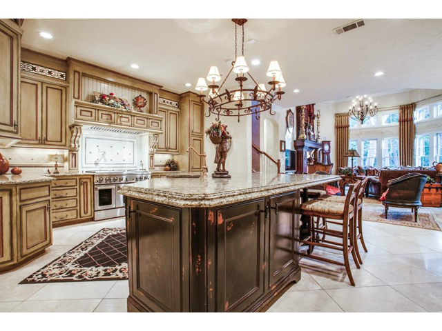 Custom gourmet kitchen features hand painted cabinetry, oversize