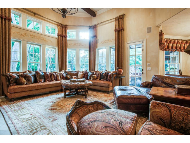 Stunning great room boasts vaulted beamed ceiling and a wall of