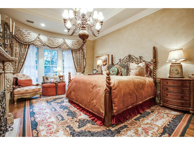 Impeccably designed master suite features bay windows, wood floo
