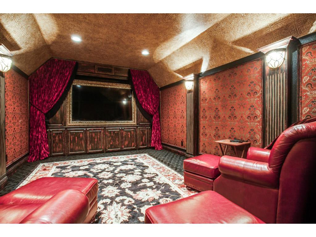 Lavishly decorated, yet cozy media room is equipped with a 93" t