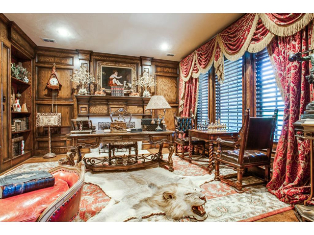 Handsome study features pocket doors, wood paneling, hidden door