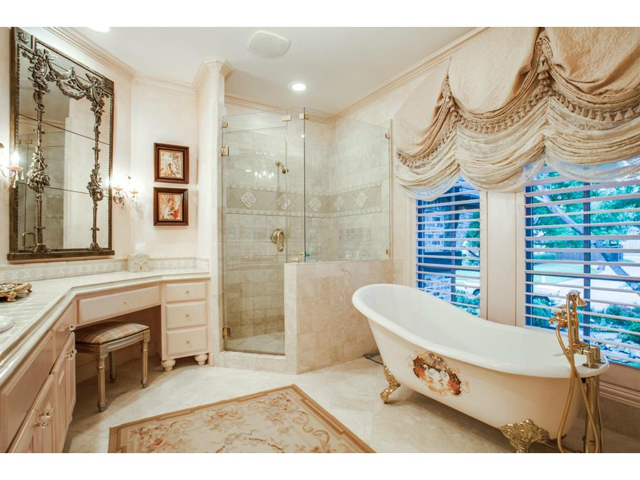 Exceptionally updated en-suite bathroom offers a gold claw antiq