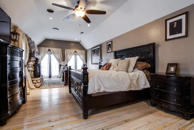 Master bed with stone fireplace
