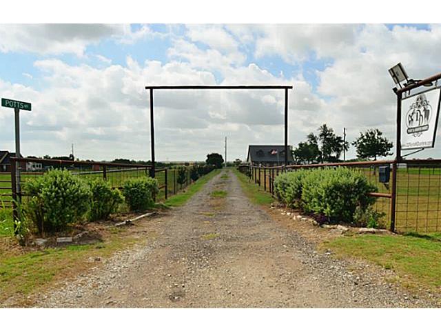 Auto gated entry with pipe fence, treelined