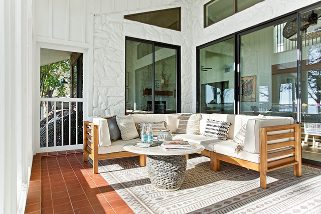 Sliding glass doors open up to a screened-in porch with views of the lake.